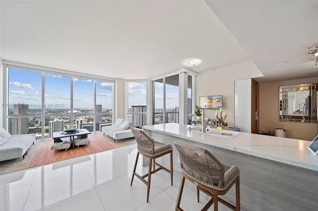 a living room with furniture and a large window