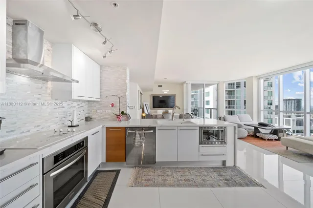 a kitchen with a sink stove and cabinets