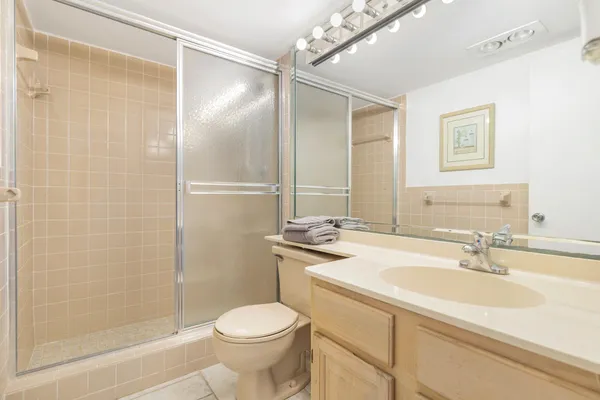 a bathroom with a sink toilet and shower