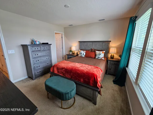 a bedroom with a bed and a dresser