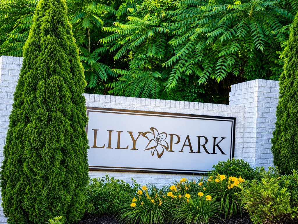 117 Alice Court Easley, SC 29642 - Photo 24 of 26 A welcoming community entrance, framed by mature evergreens and vibrant landscaping.