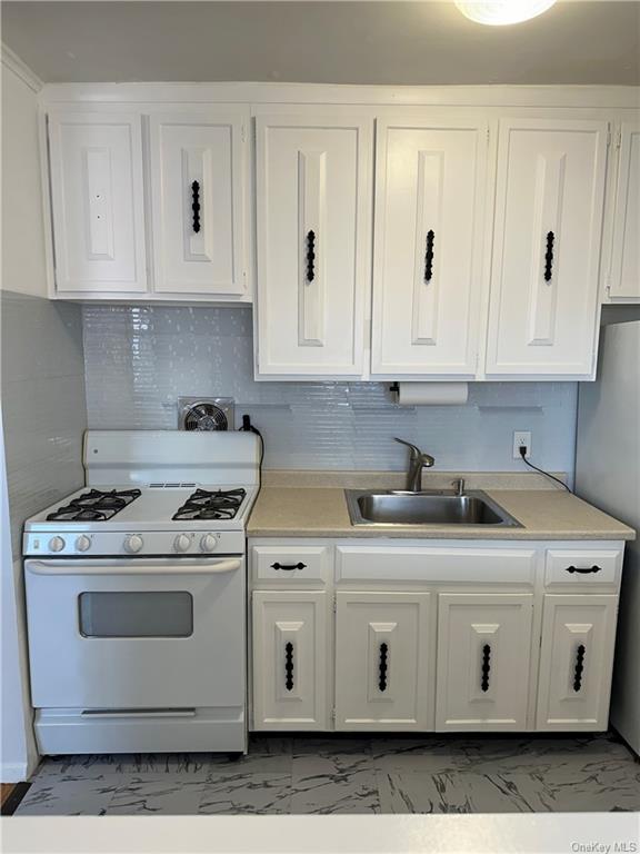 a kitchen with stainless steel appliances granite countertop white stove a sink and dishwasher
