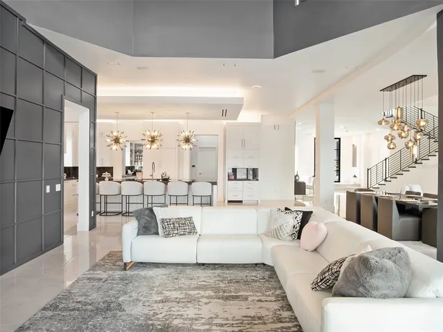a view of living room with furniture and a chandelier