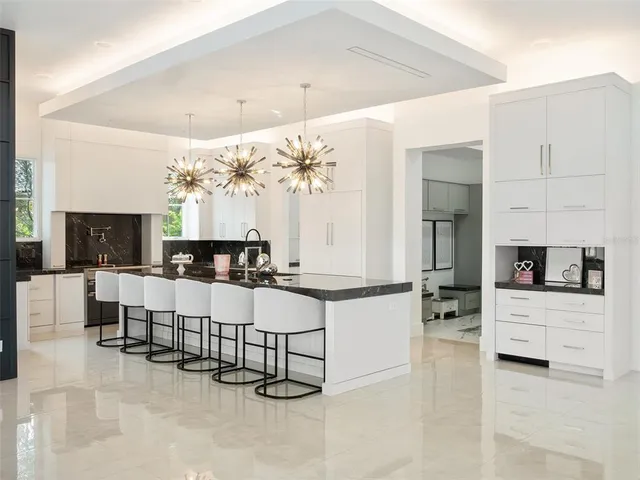 a living room with furniture large window and wooden floor