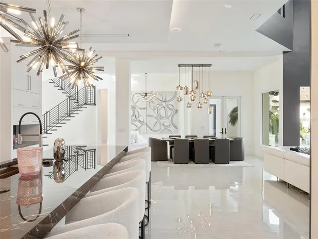 a spacious bedroom with a bed a couch and a large window