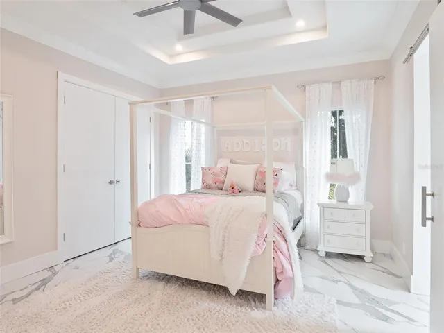 a view of hallway with a large window and chandelier