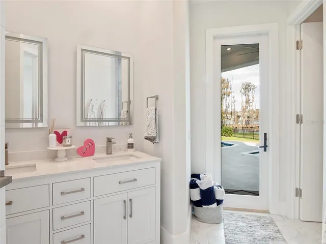 a bathroom with a bathtub sink and mirror
