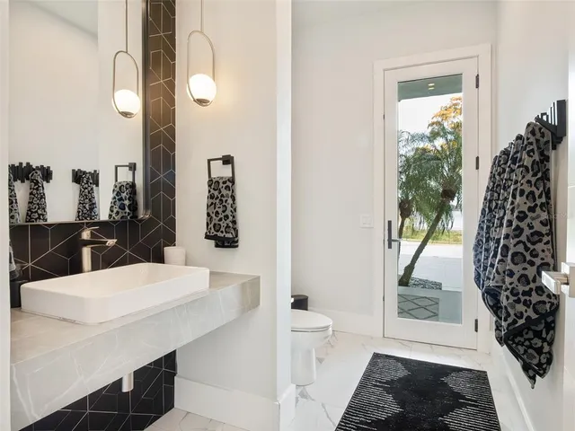 a front view of a house with swimming pool having outdoor seating