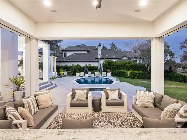 a living room with furniture and a floor to ceiling window