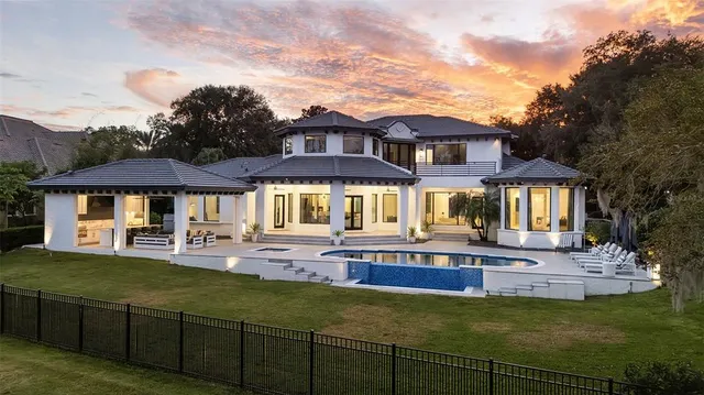 a front view of a house with swimming pool having outdoor seating
