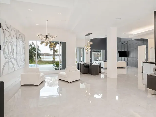 a spacious bedroom with a bed and a flat screen tv