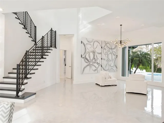 a living room with furniture and large windows