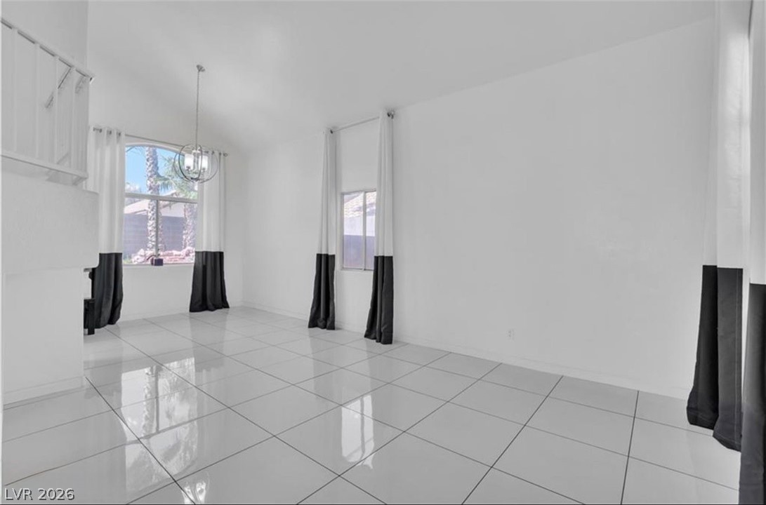 6429 Winding Ridge Las Vegas, NV 89156 - Photo 16 of 22 Voluminous ceilings and polished tile flooring define this airy living space.