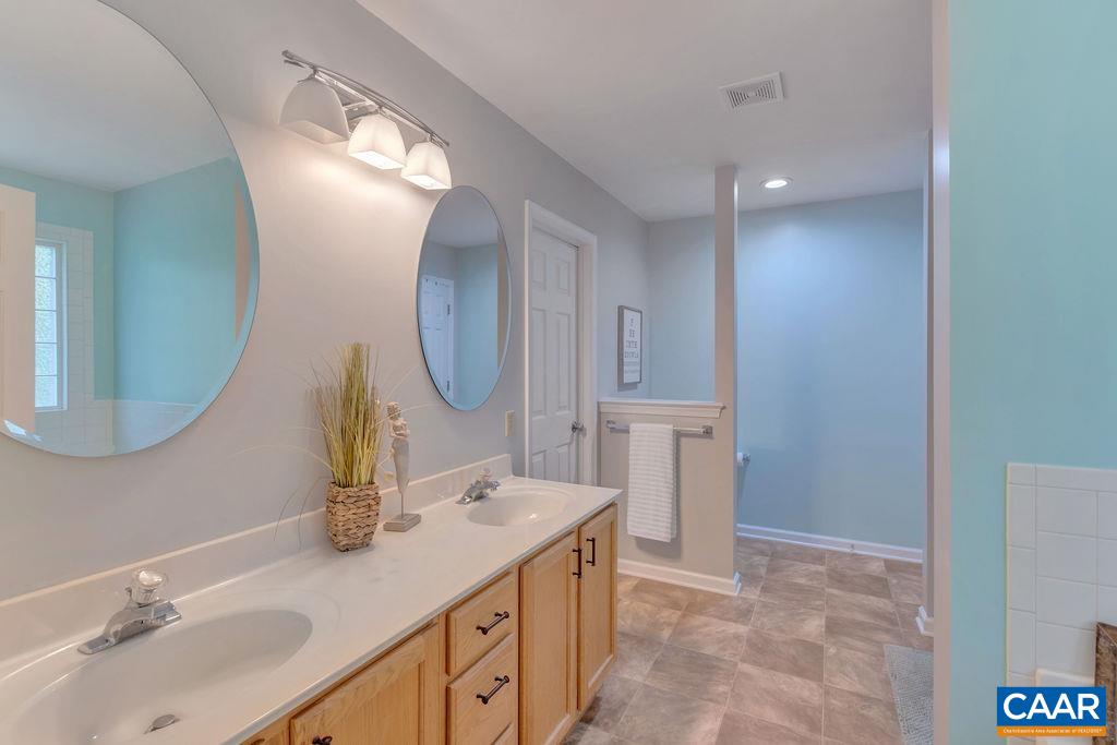 421 Rudolph Street Ruckersville, VA 22968 - Photo 35 of 42 a bathroom with a sink and a mirror