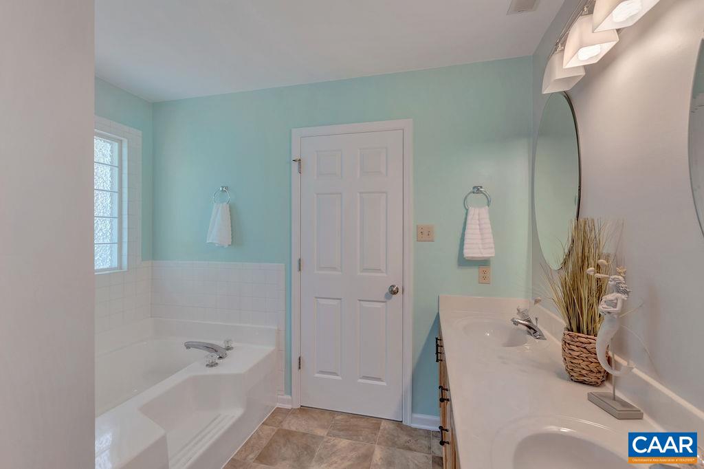 421 Rudolph Street Ruckersville, VA 22968 - Photo 36 of 42 a bathroom with a tub sink and mirror
