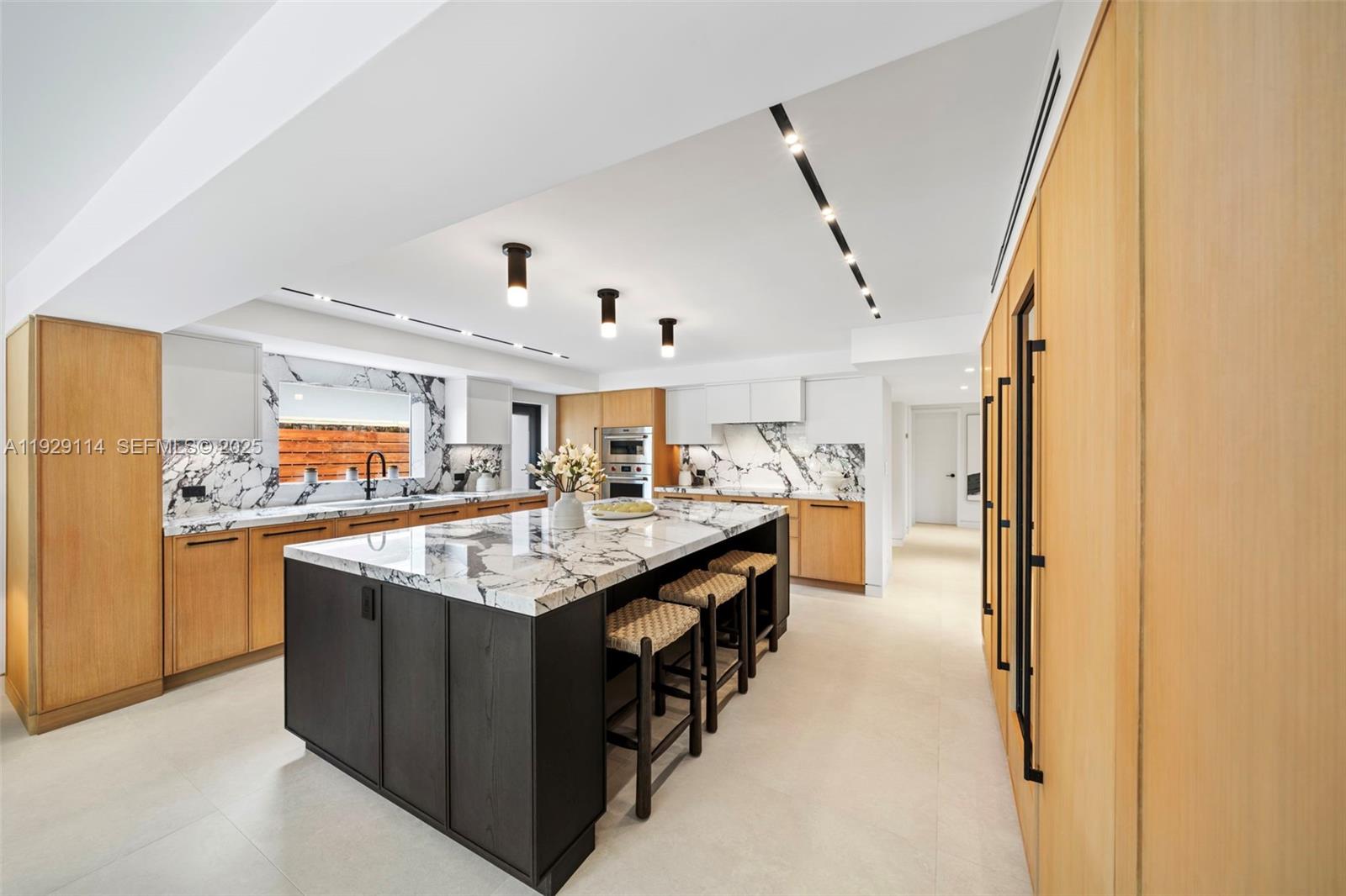 1815 Fairhaven Place Miami, FL 33133 - Photo 15 of 59 a kitchen with stainless steel appliances granite countertop a sink and stove