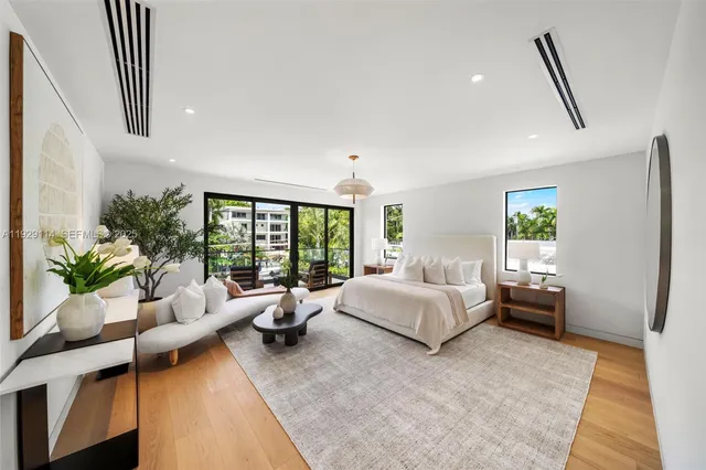 a kitchen with kitchen island a counter top space wooden floor and stainless steel appliances