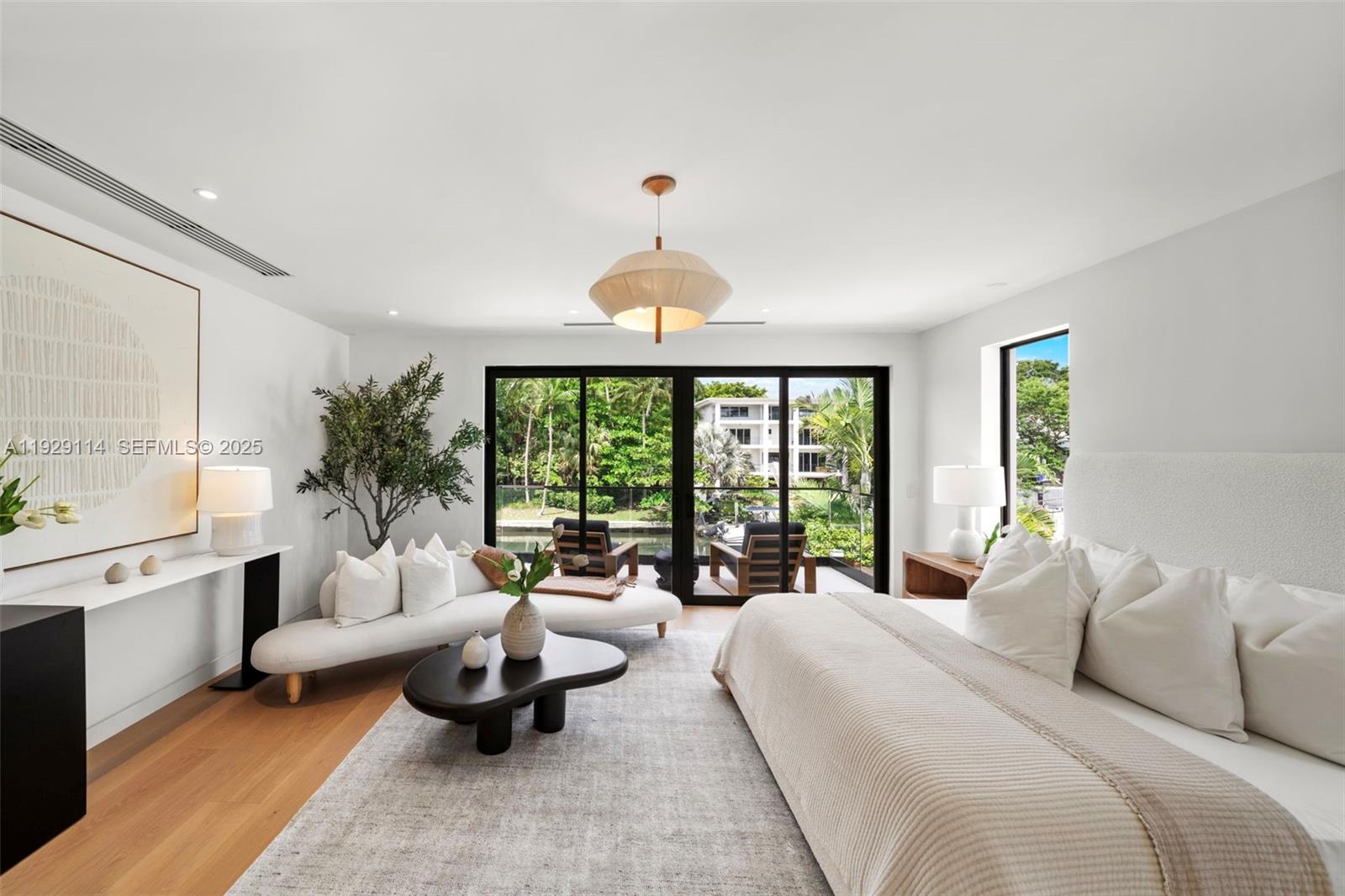 1815 Fairhaven Place Miami, FL 33133 - Photo 21 of 59 a spacious bedroom with a bed a couch and large window