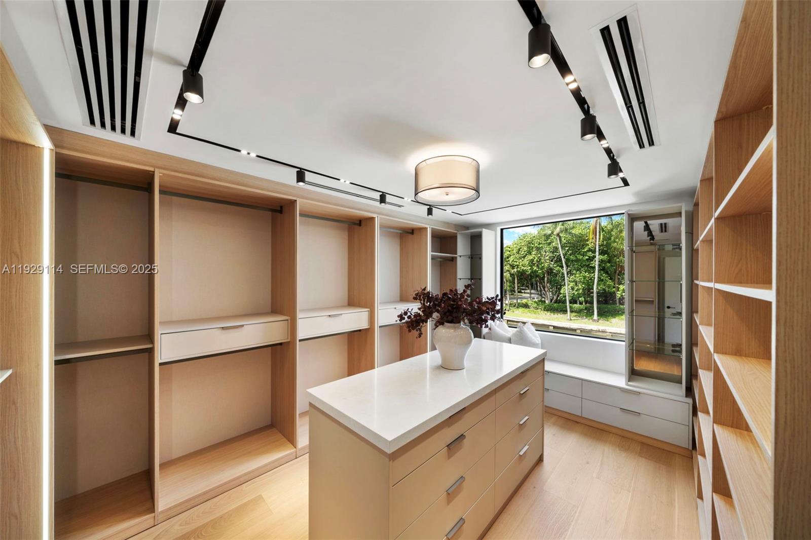 1815 Fairhaven Place Miami, FL 33133 - Photo 25 of 59 a kitchen with kitchen island a counter top space wooden floor and stainless steel appliances