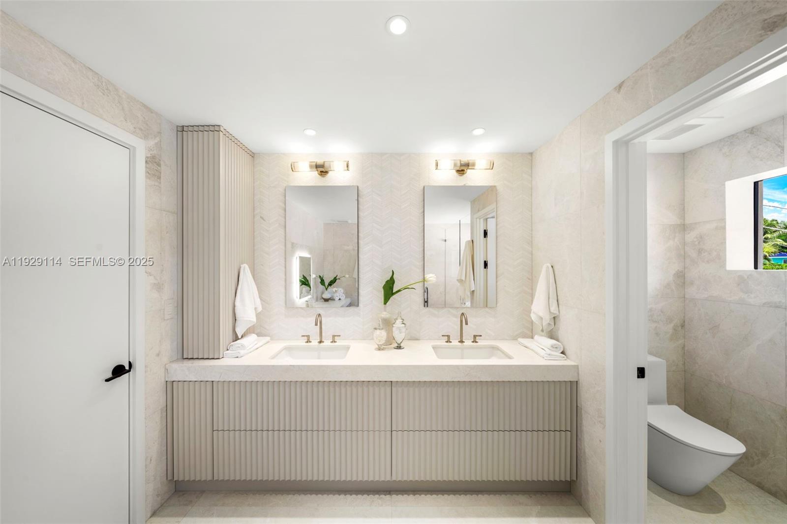 1815 Fairhaven Place Miami, FL 33133 - Photo 27 of 59 a bathroom with a double vanity sink and a mirror