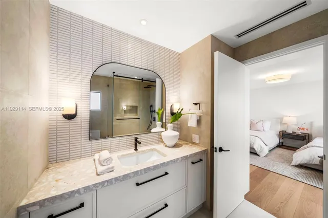 a bathroom with a sink toilet and mirror