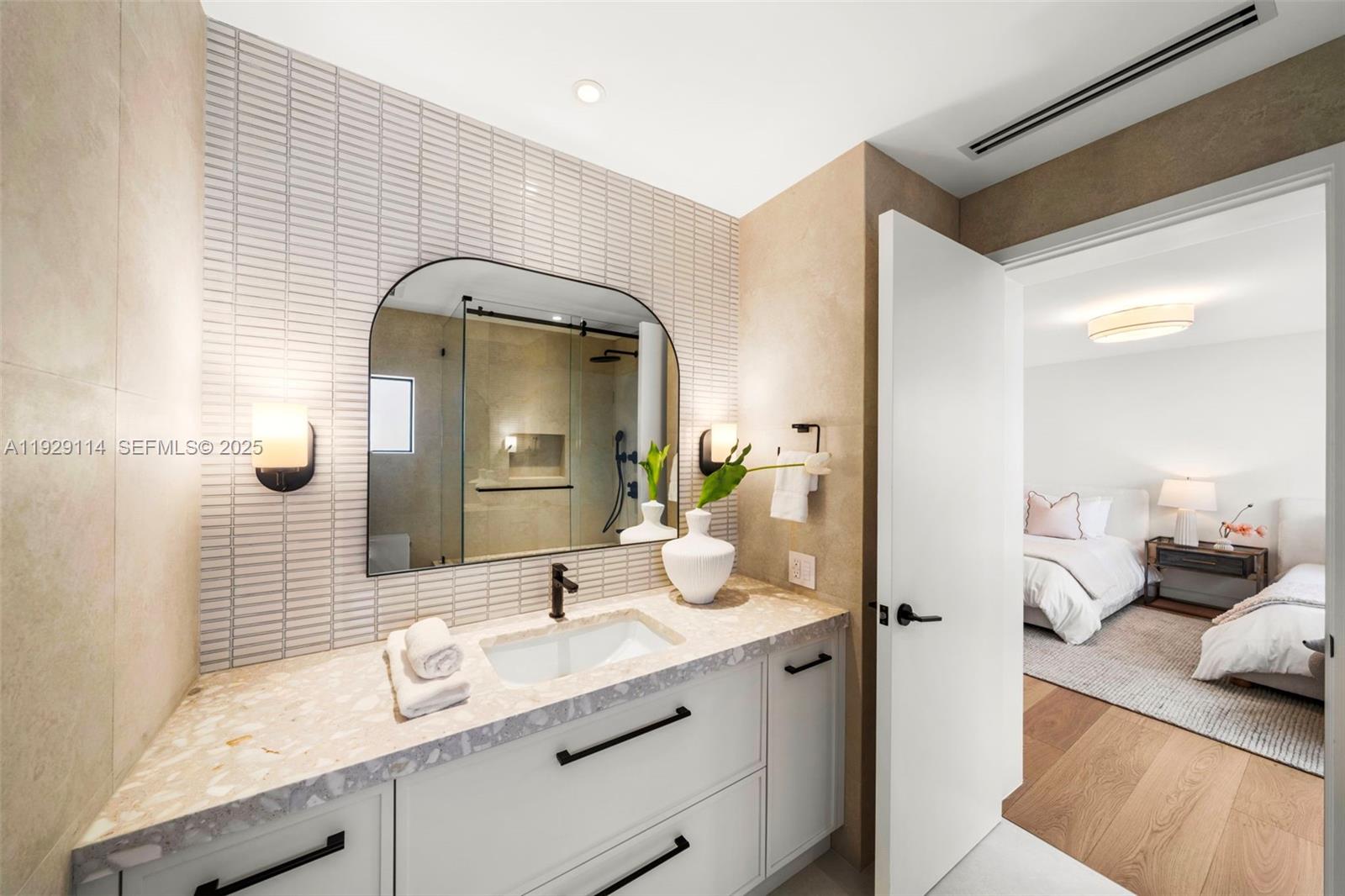 1815 Fairhaven Place Miami, FL 33133 - Photo 31 of 59 a en suite bathroom with a granite countertop sink and a mirror