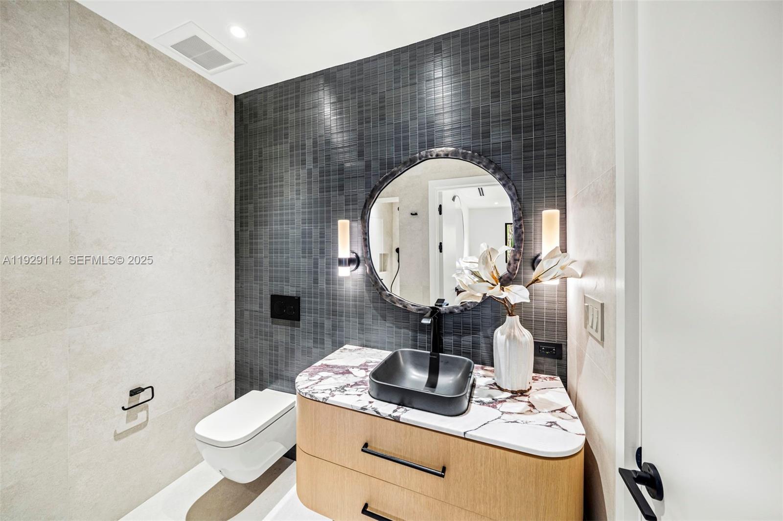 1815 Fairhaven Place Miami, FL 33133 - Photo 38 of 59 a bathroom with a sink toilet and mirror