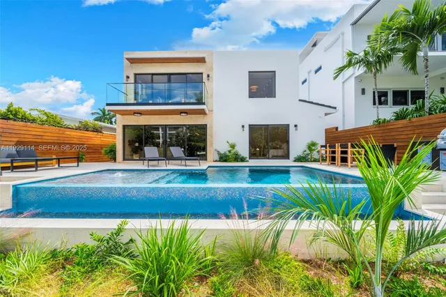 a aerial view of a house with a garden and lake view