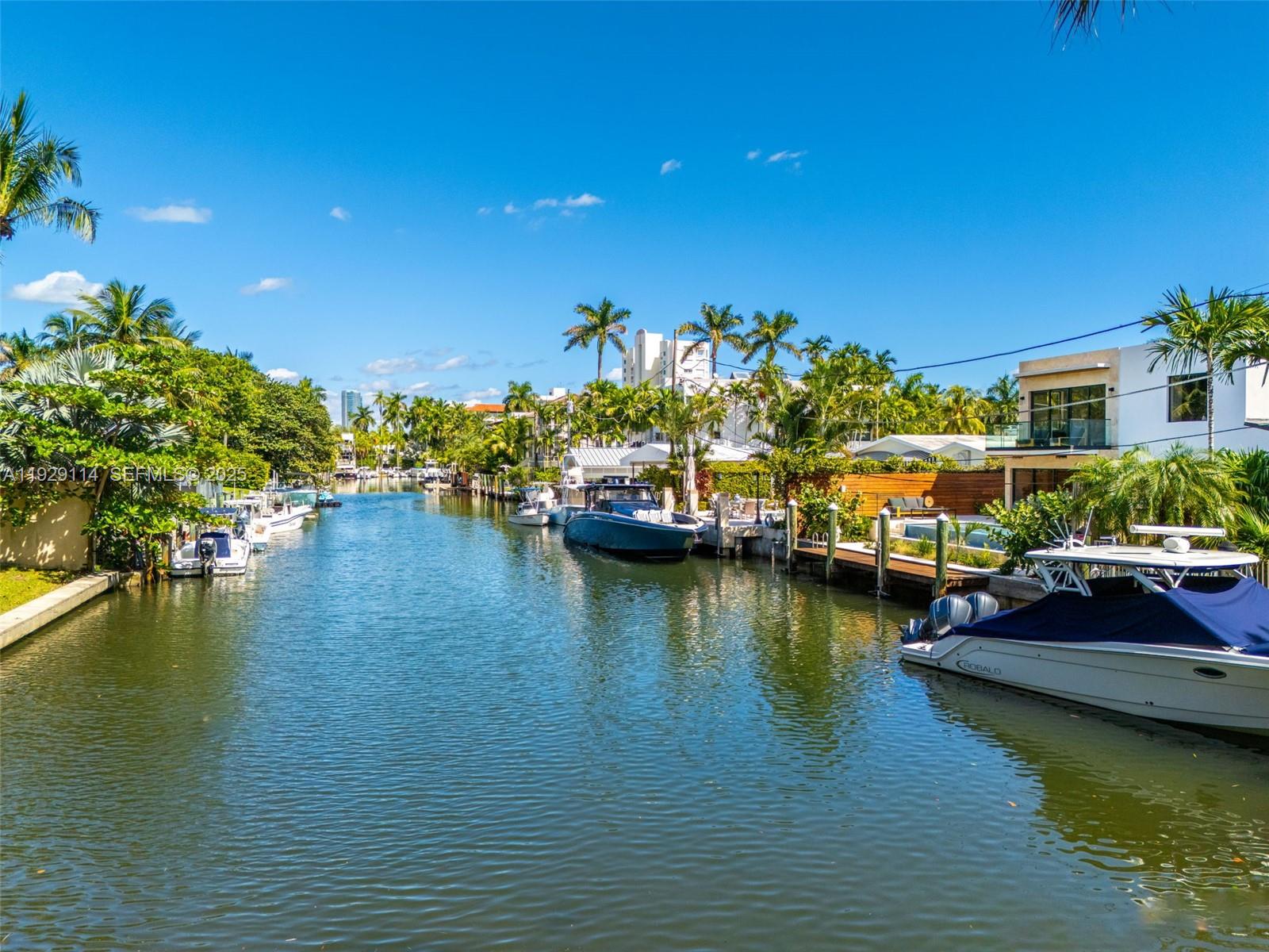 1815 Fairhaven Place Miami, FL 33133 - Photo 51 of 59 a view of a lake with boats and trees in the background