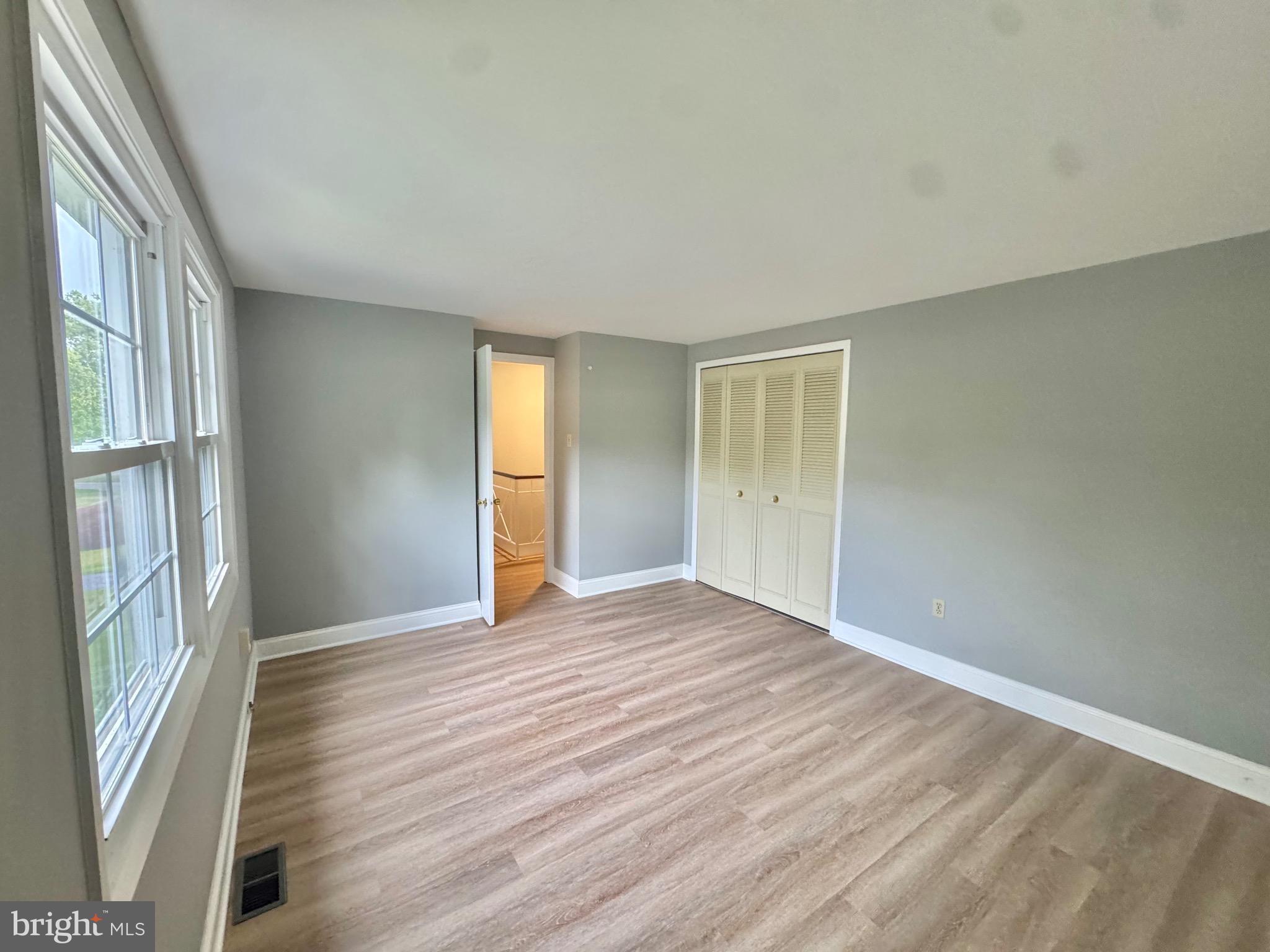 4908 Rocky Spring Lane Bowie, MD 20715 - Photo 24 of 36 a view of an empty room with wooden floor and a window