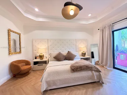 a bedroom with a bed window and a television
