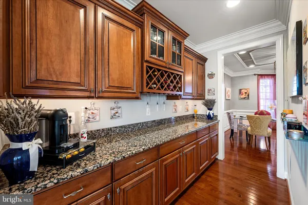 a kitchen with stainless steel appliances kitchen island granite countertop a table and chairs in it