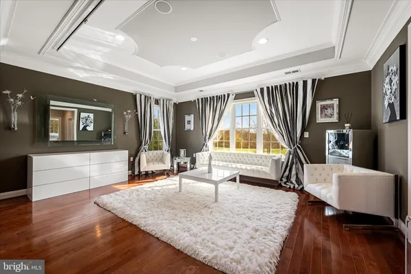 a large kitchen with kitchen island a stove a sink dishwasher and a dining table with wooden floor