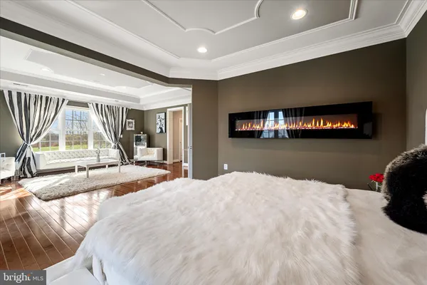 a living room with furniture a rug and a painting