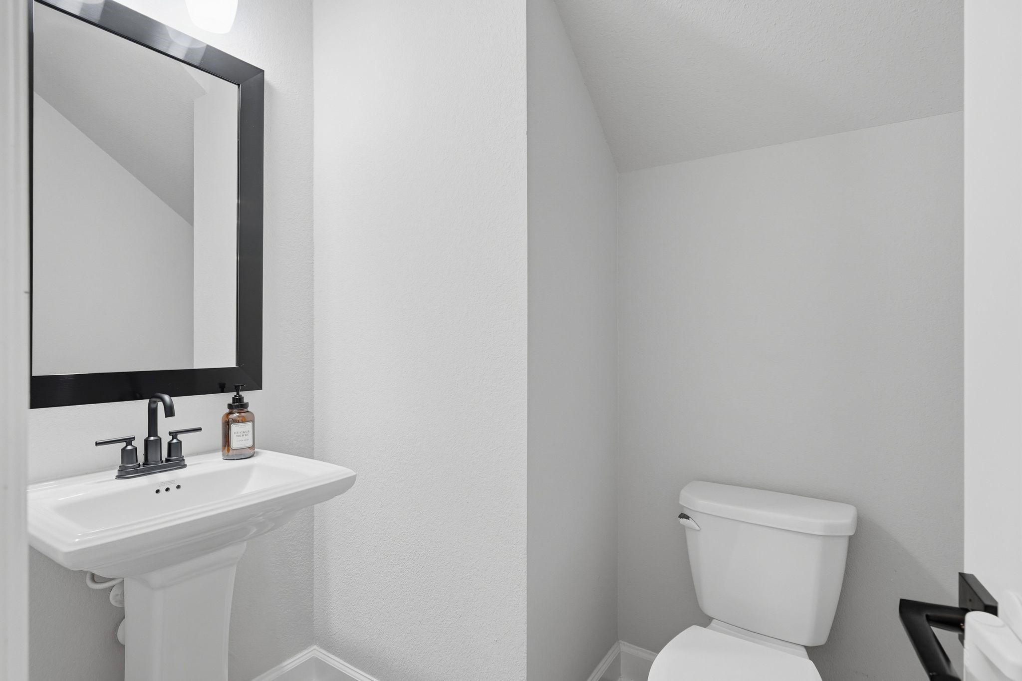 24423 Morningside Terrace Tomball, TX 77375 - Photo 23 of 47 a bathroom with a toilet sink and mirror