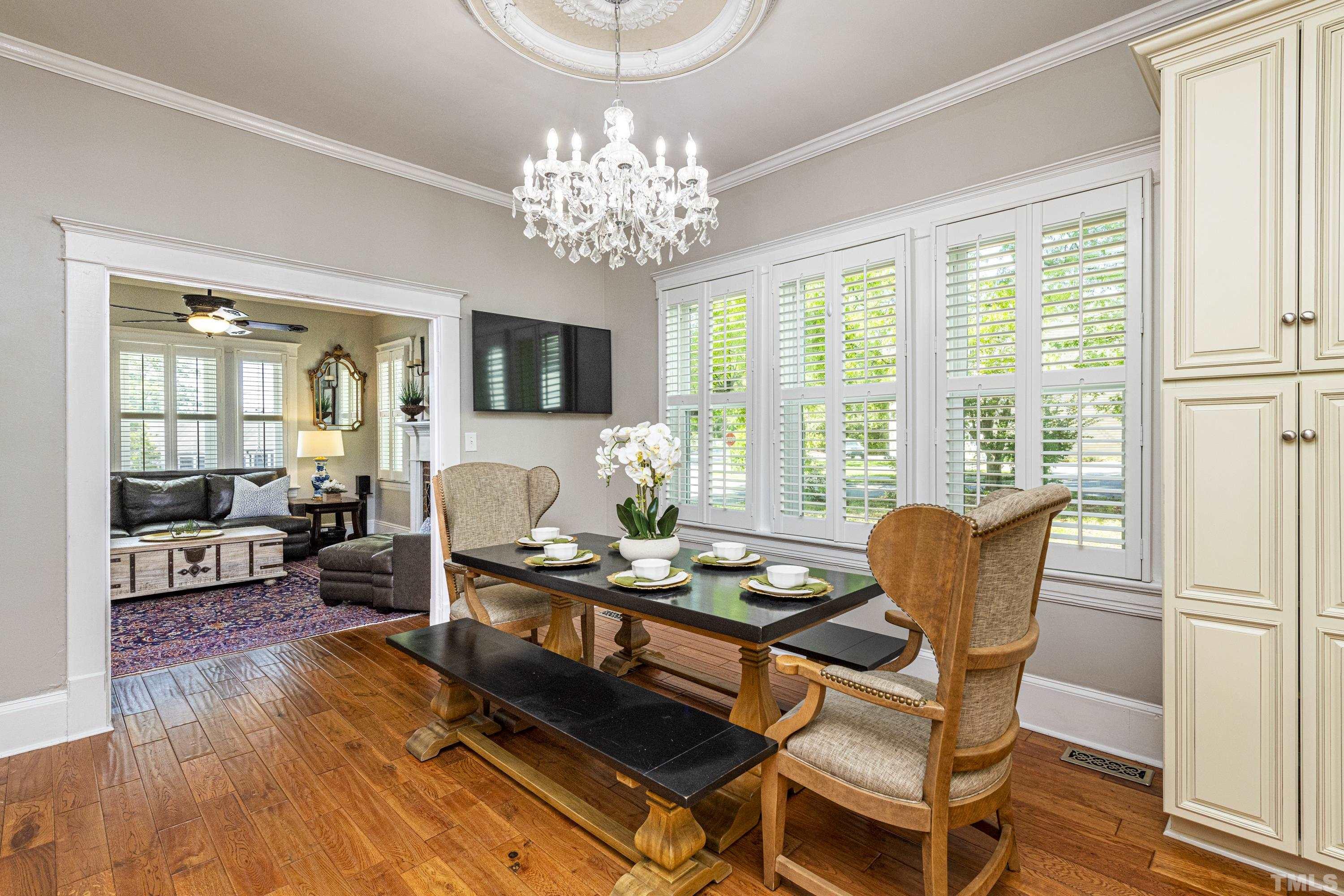 208 Ashe Avenue Raleigh, NC 27605 - Photo 12 of 66 a living room with patio furniture and a chandelier