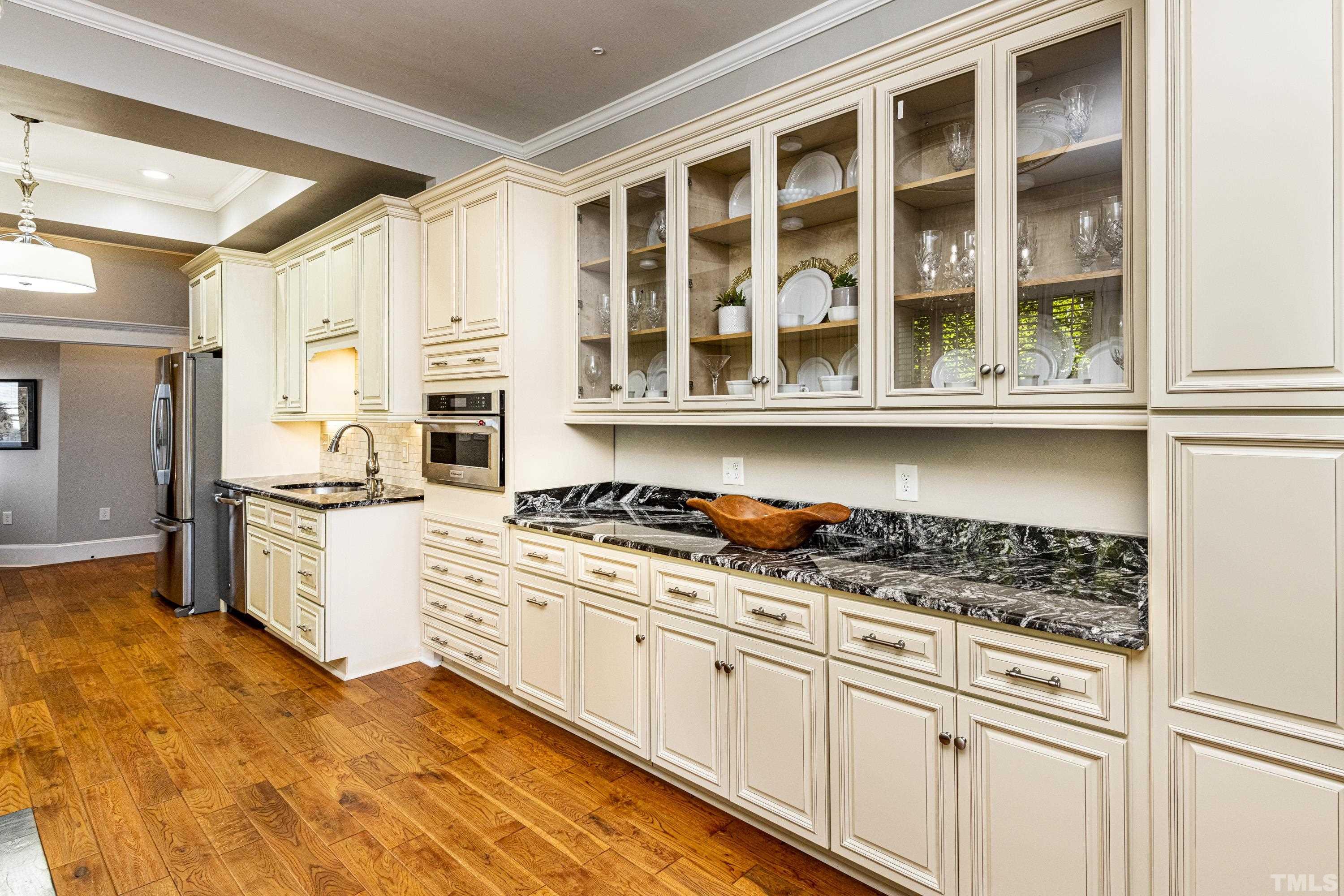 208 Ashe Avenue Raleigh, NC 27605 - Photo 14 of 66 a kitchen with stainless steel appliances granite countertop a stove and a white cabinets