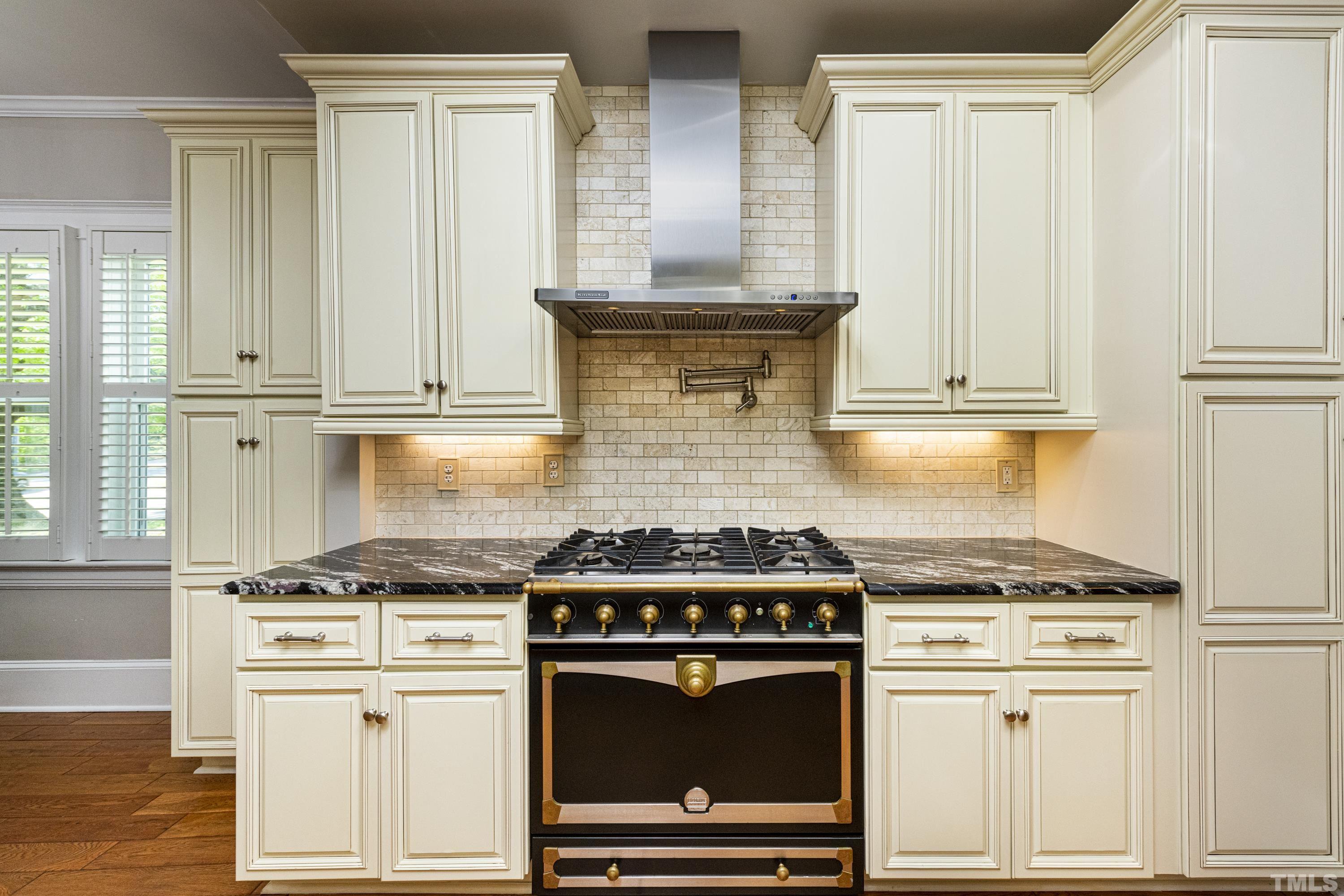 208 Ashe Avenue Raleigh, NC 27605 - Photo 17 of 66 a kitchen with granite countertop a stove and a white cabinets
