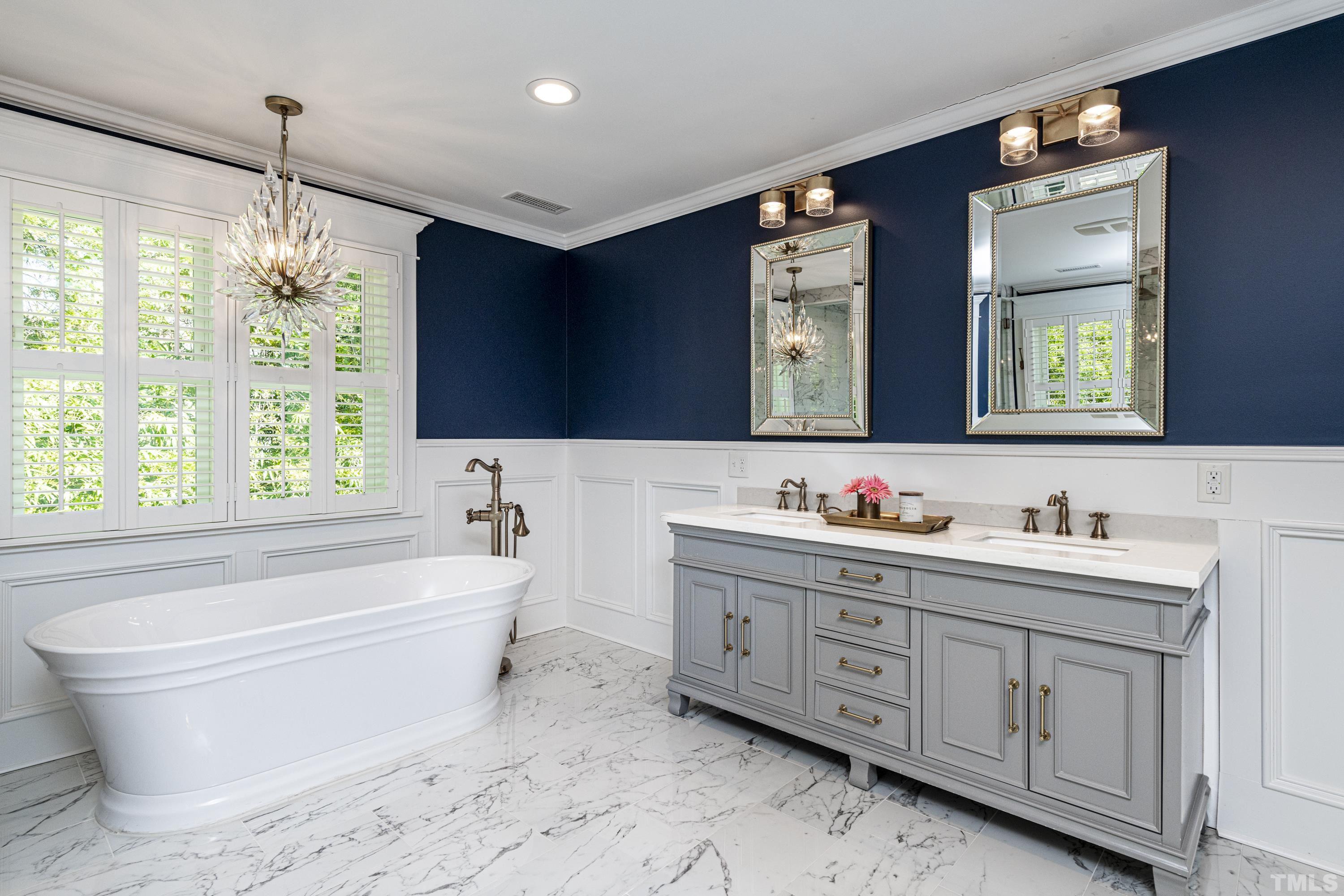 208 Ashe Avenue Raleigh, NC 27605 - Photo 42 of 66 a bathroom with a bathtub sink and mirror
