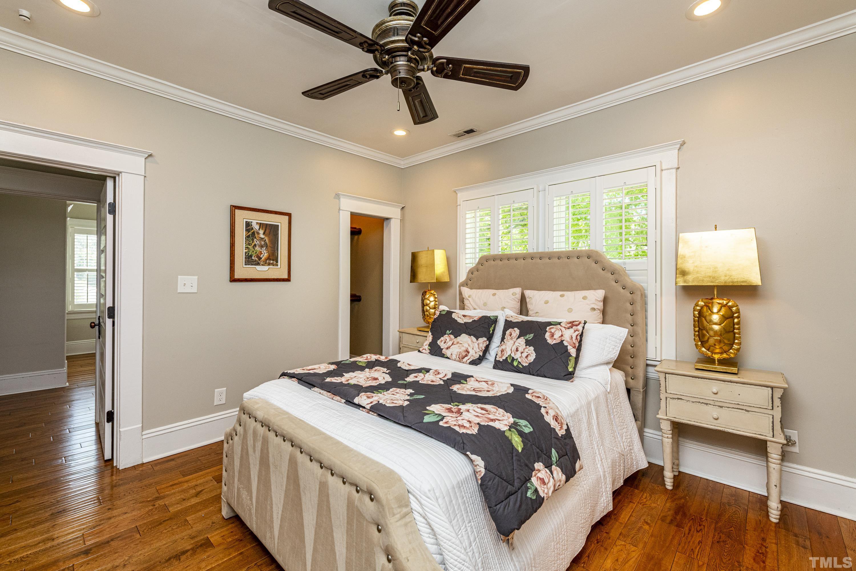 208 Ashe Avenue Raleigh, NC 27605 - Photo 45 of 66 a bedroom with a bed and a chandelier