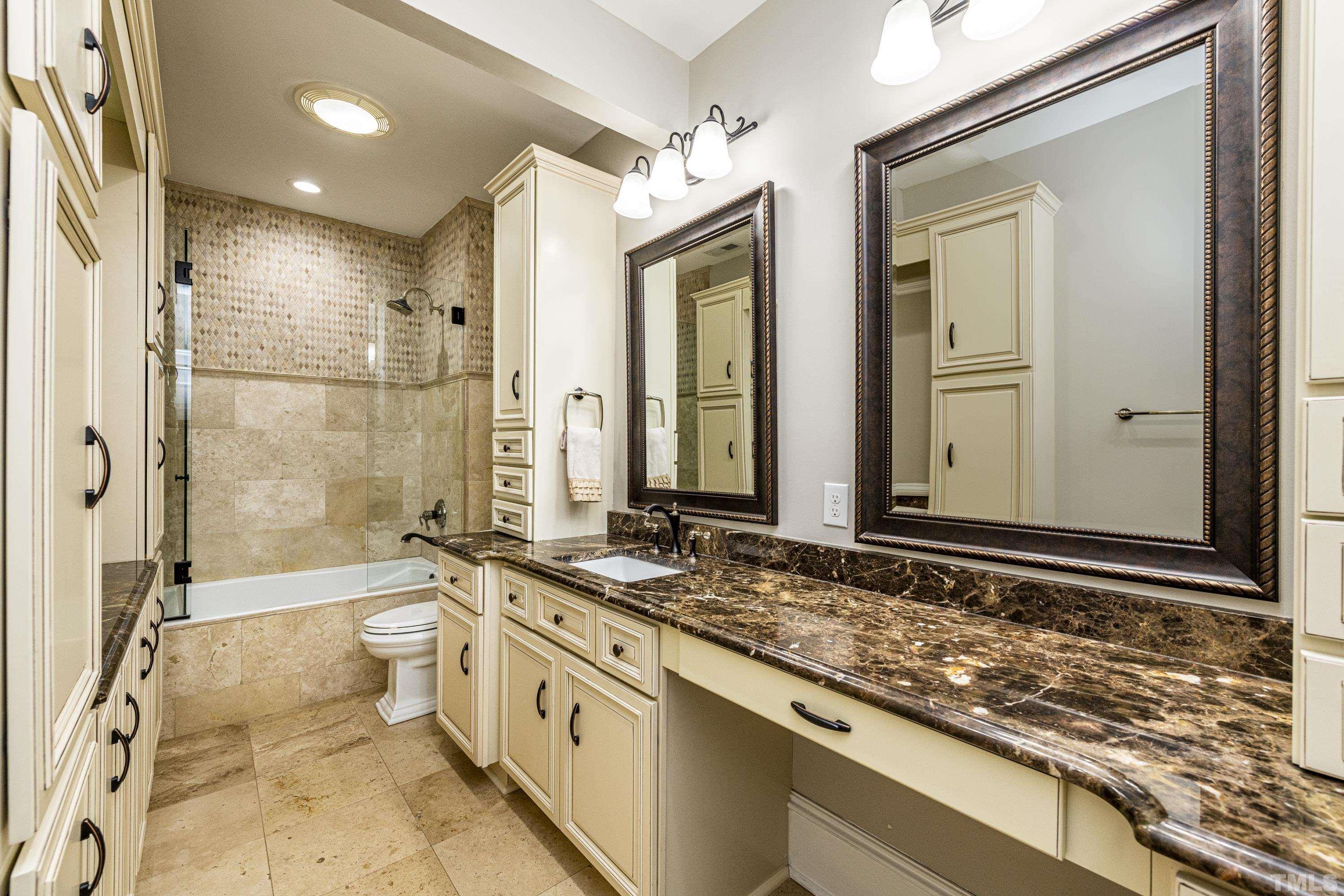 208 Ashe Avenue Raleigh, NC 27605 - Photo 46 of 66 a bathroom with a granite countertop tub sink and mirror