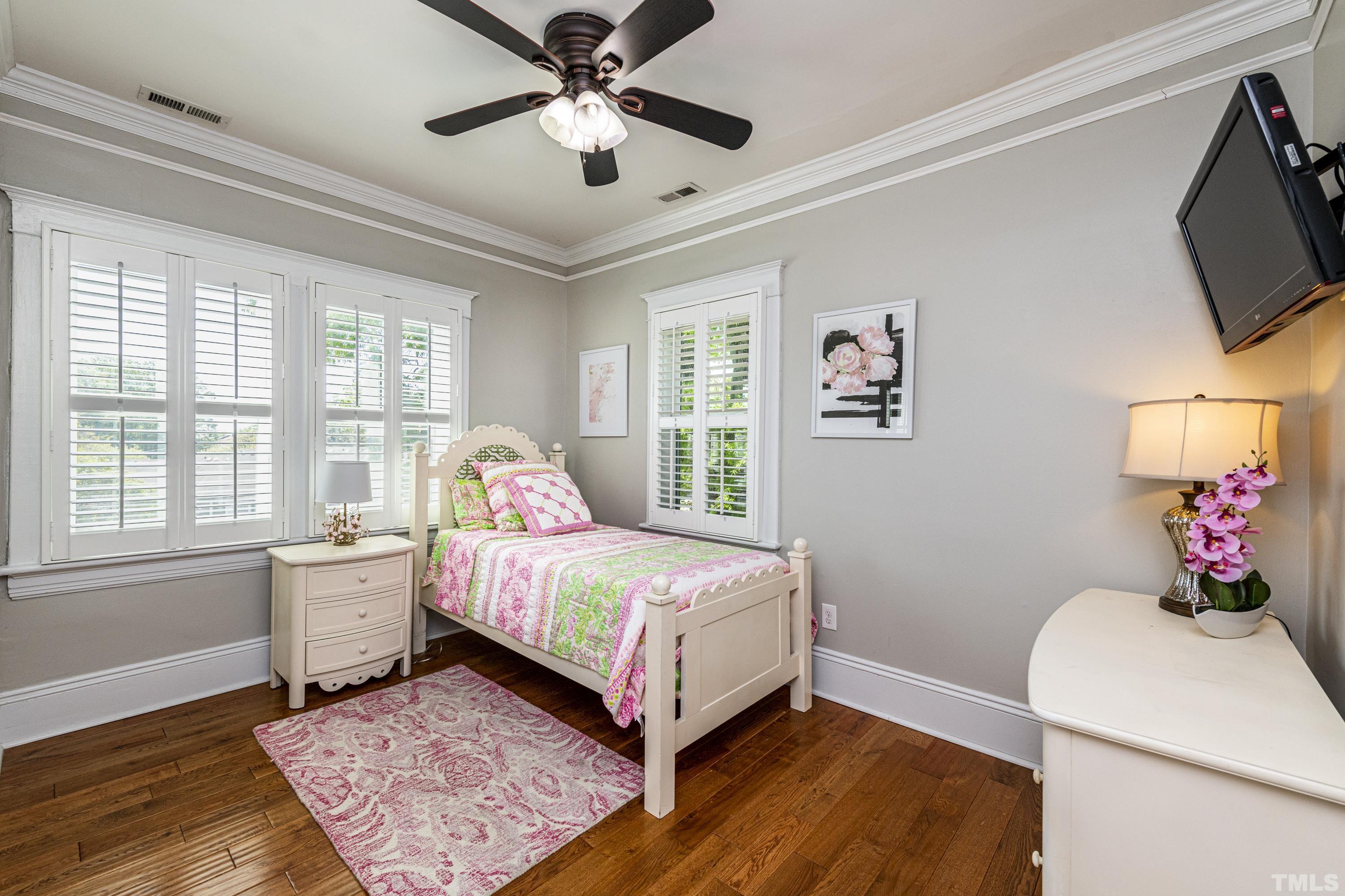 208 Ashe Avenue Raleigh, NC 27605 - Photo 49 of 66 a bedroom with a bed dresser and wooden floor