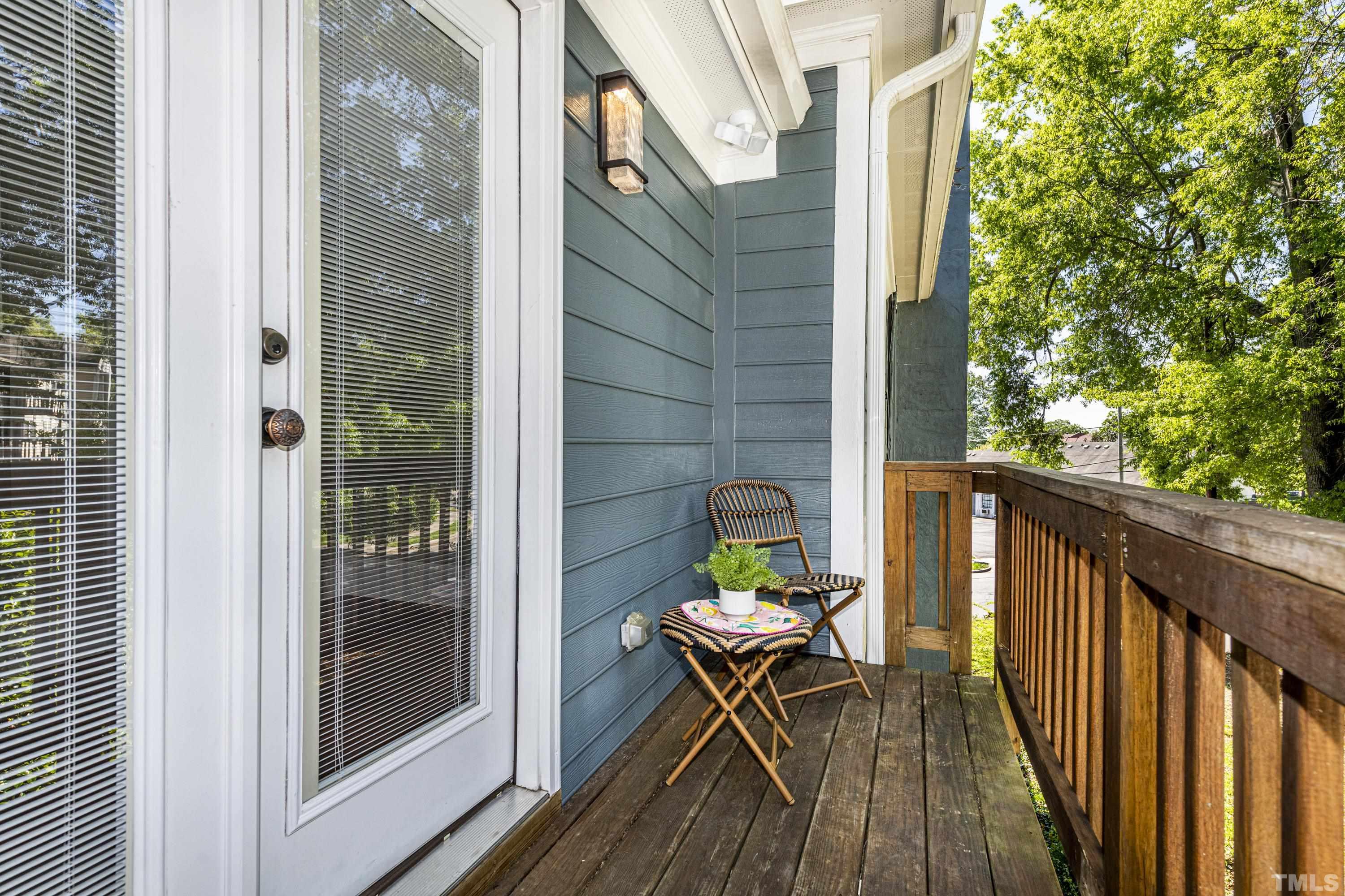 208 Ashe Avenue Raleigh, NC 27605 - Photo 57 of 66 a balcony with wooden floor table and chairs