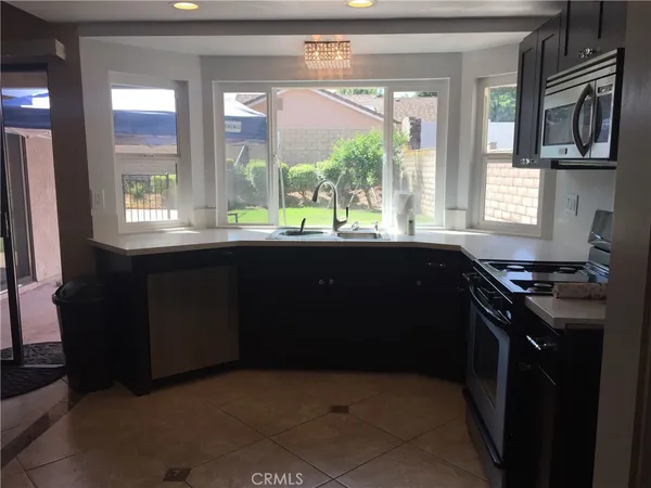 a kitchen with a sink stove and microwave