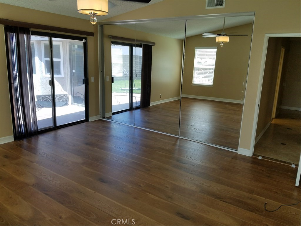50 Village Loop Road Phillips Ranch, CA 91766 - Photo 19 of 48 an empty room with wooden floor and windows