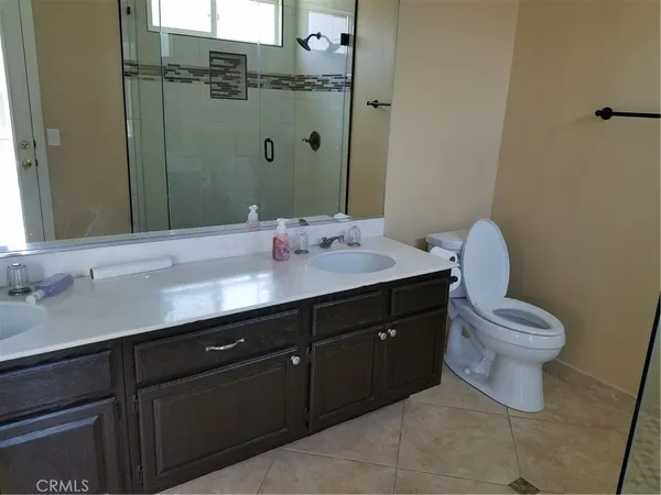 a bathroom with a sink vanity mirror and toilet