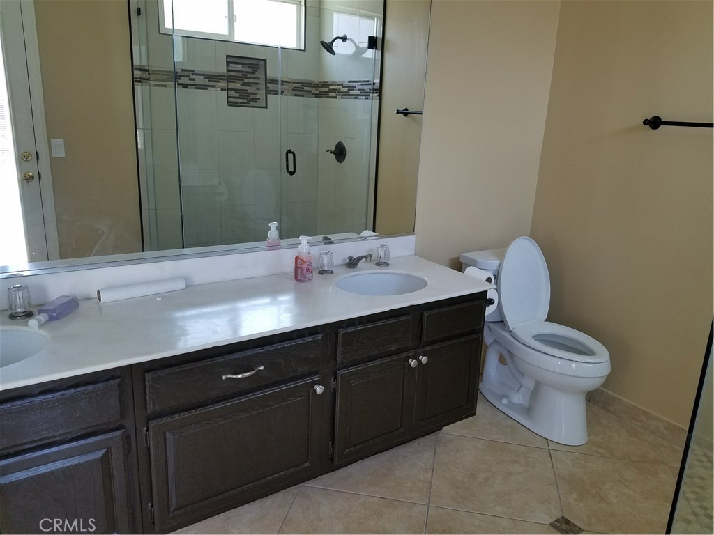 50 Village Loop Road Phillips Ranch, CA 91766 - Photo 20 of 48 a bathroom with a sink vanity mirror and toilet