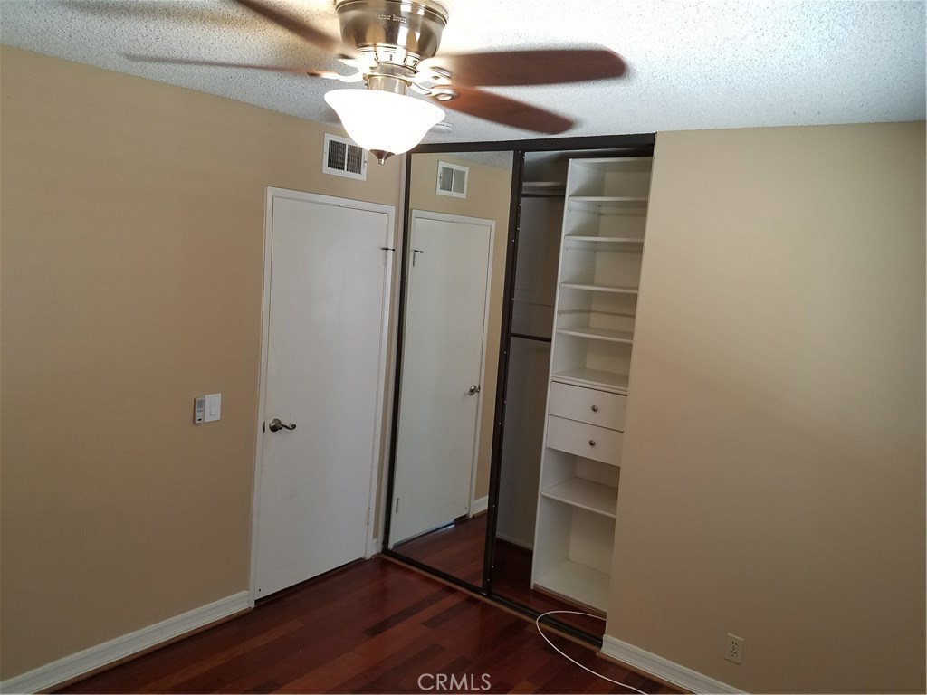 50 Village Loop Road Phillips Ranch, CA 91766 - Photo 24 of 48 a view of a hallway with wooden floor and front door