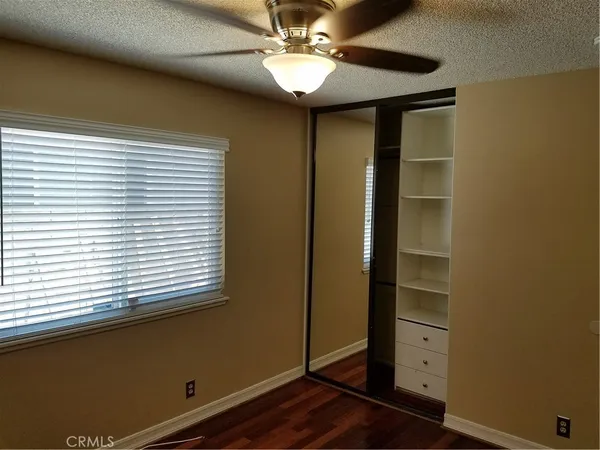 a view of room with window and wooden floor