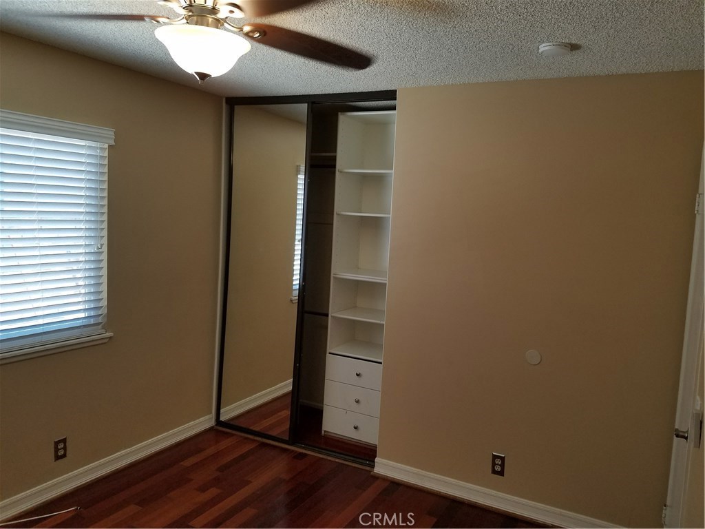 50 Village Loop Road Phillips Ranch, CA 91766 - Photo 31 of 48 a view of an empty room with a window and wooden floor
